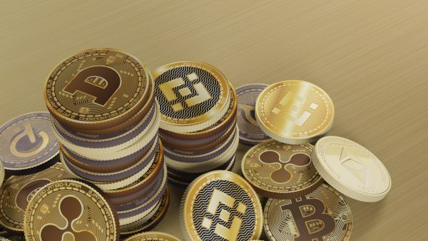 Versões simbólicas de principais moedas digitais reunidas aos montes em uma superfície