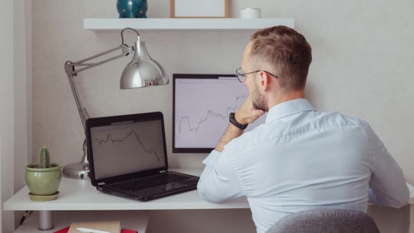 Investidor buscando formas de diminuir risco de quedas na carteira analisando o histórico de oscilação de ações