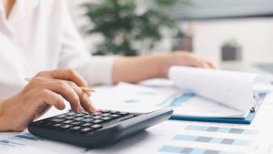 Investidora analisando dados da empresa que pretende investir e calculando nopat para avaliar performance