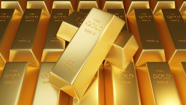 Múltiplas barras de ouro representando investimento no metal
